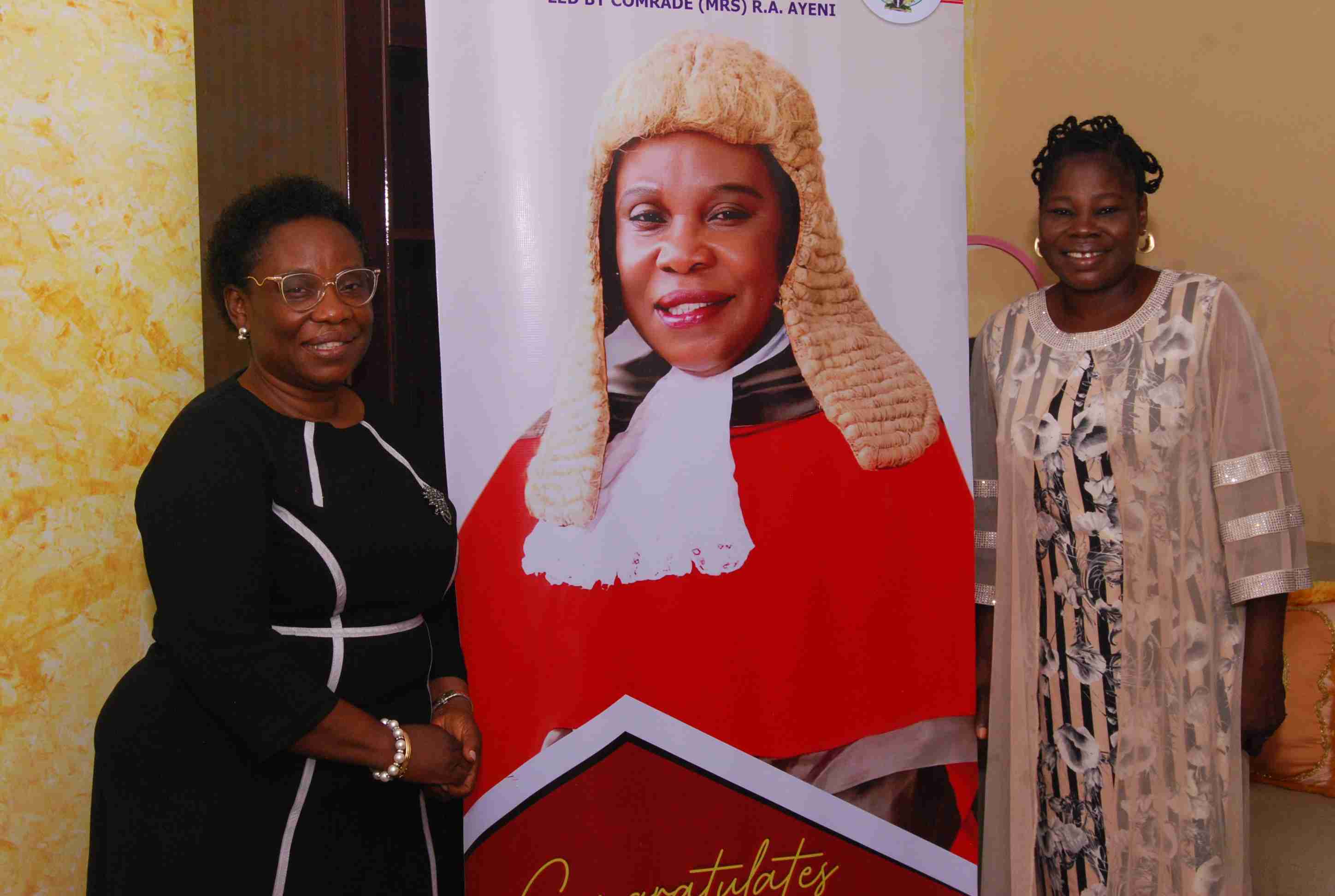 The PCCA (Hon. Justice M.O. Abodunde) taking a Snapshot with The Congratulatory Banner to Him By The JUSUN Executives on 22nd March, 2023.